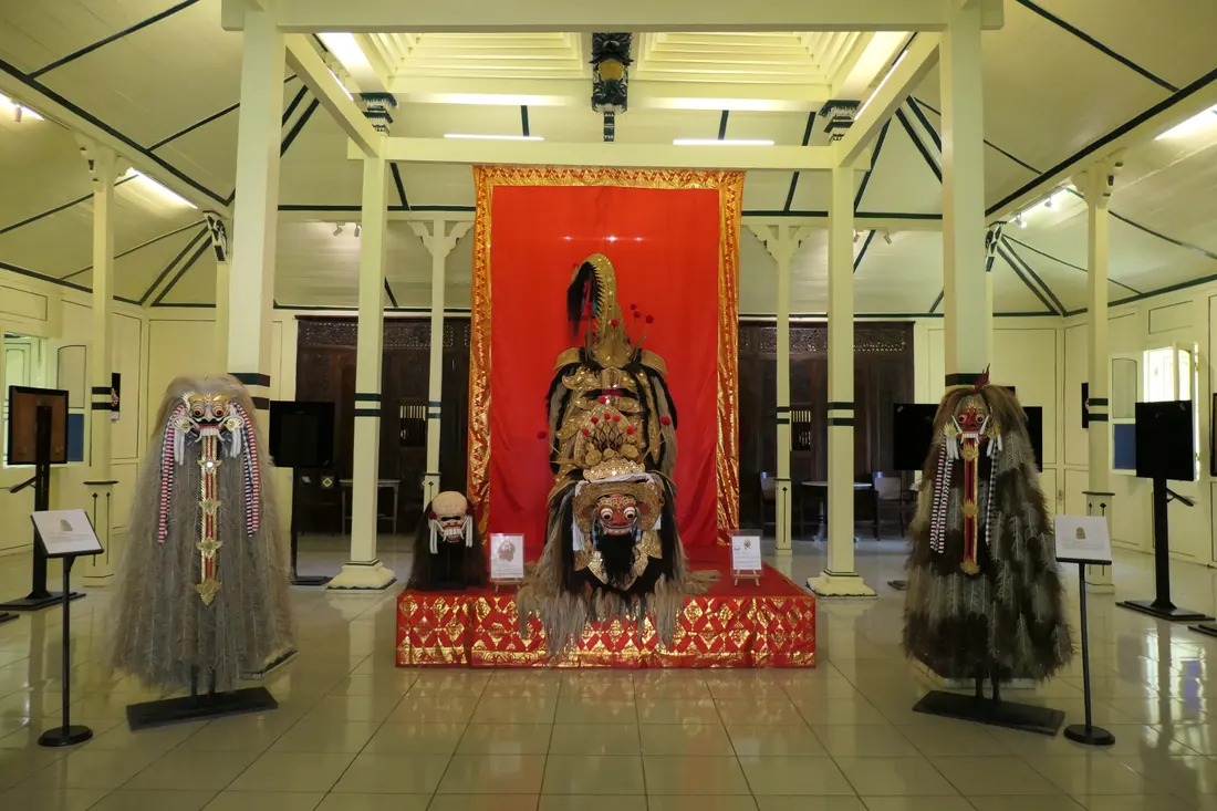 A colourful Balinese Barong costume with an ornate carved and gilded mask
